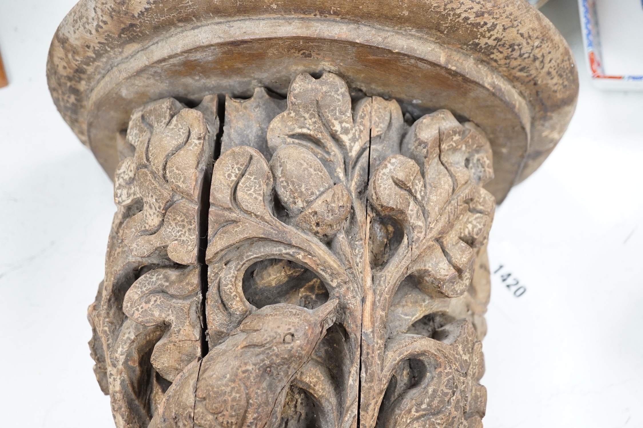A Victorian/Edwardian carved pine wall bracket, carved with a bird within scrolling oak leaves, 36cms high
